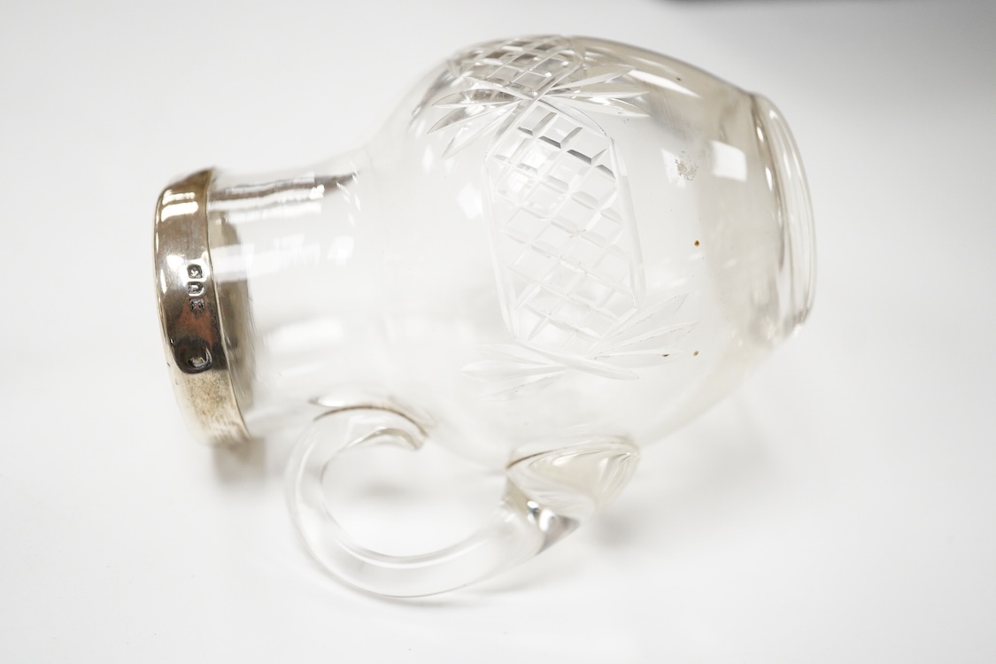 A George VI silver sugar bowl, Viners Ltd, Sheffield, 1946, diameter 10.9cm, together with a cased silver spoon & pusher and a silver mounted glass liquor jug.
